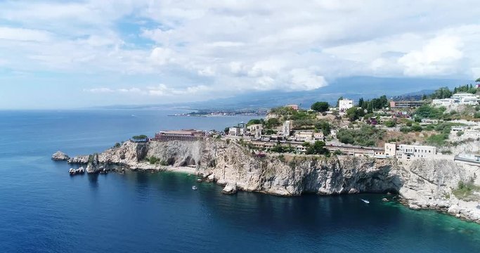 Panoramic aerial view of Cefalu sea port and Tyrrhenian Sea coast, Sicily, Italy. Cefalu city is one of the major tourist attractions in the region. View from Rocca di Cefalu. 4K, 50fps, slowmotion