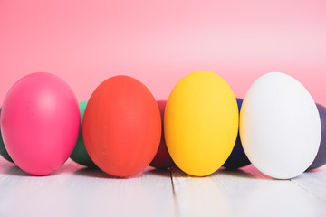 Easter eggs clean on wooden and pink background