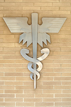 Medical Symbol or Emblem onLight Tan Brick Wall