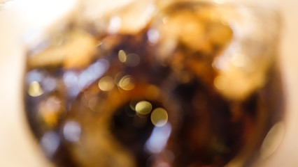 fresh fizzy of soda in the glass with bubbles background and ice cubes
