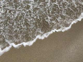 Fototapeta na wymiar Wave on Sand