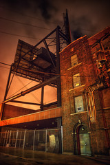 Industrial city alley street with a dramatic billboard installation in Chicago at night