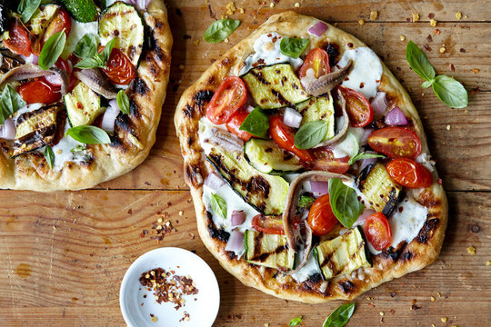 Homemade Grilled Pizza On Wood Surface