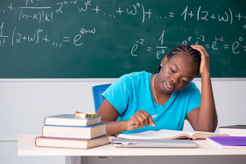 Black female student in front of chalkboard  