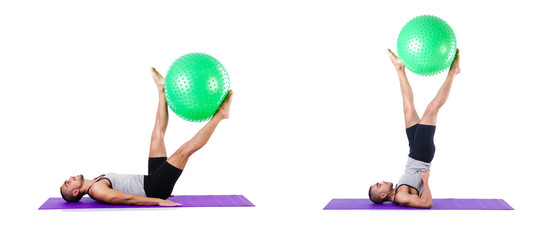 Man with swiss ball doing exercises on white
