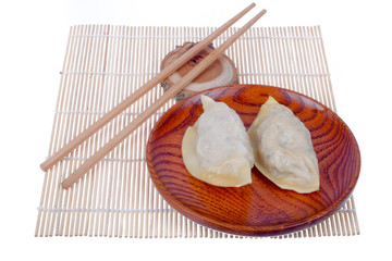 Dim Sum Chinese Dumplings and chopsticks with sauce  isolated on white background, with clipping path .