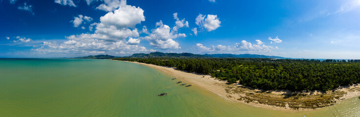 Fototapeta na wymiar Aerial panoramic view of a tropical sandy beach and traditional longtail boats (Cape Pakarang, Thailand)