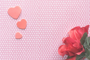 Pink heart shapes on white heart pattern background with roses