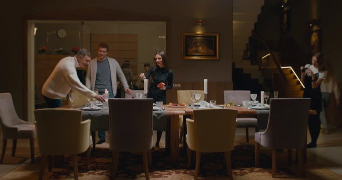 WS Large Family Or Group Of Friends Setting The Table, Preparing For A Dinner. 4K UHD 60 FPS SLOW MOTION Blackmagic RAW