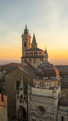 Fototapeta na wymiar Bergamo, Italy. The old town. Aerial view of the Basilica of Santa Maria Maggiore and the chapel Colleoni during the sunset