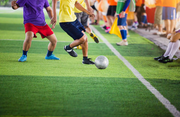 soccer players run to trap and control the ball for shoot to goal with cheerleader team background.