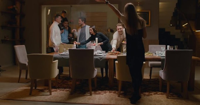 WS Large family or group of friends gather around near dining table to make a photo. 4K UHD 60 FPS SLOW MOTION Blackmagic RAW