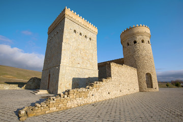 Fototapeta na wymiar Reconstructed towers of the ancient Shemakhan fortress close up