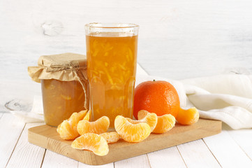 Citrus jam in glass jars and orange slices