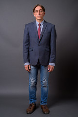 Full length shot of mature handsome Italian businessman standing