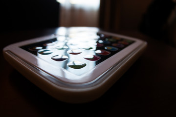 remote control being backlit by the sun