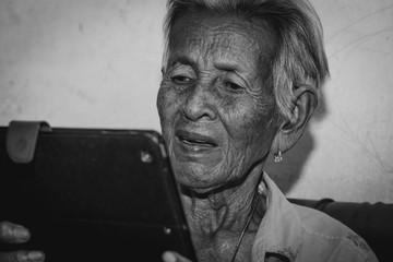 Senior woman playing tablet