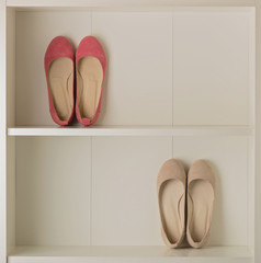 Women's shoes (ballet shoes) in the white wardrobe.
