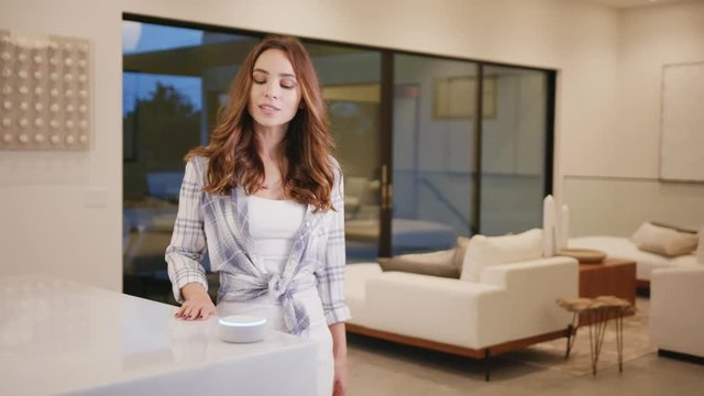 Woman taking to home assistant in smart modern house 