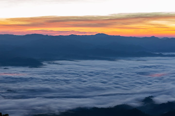 Mountain and foggy at morning time with orange sky, beautiful landscape in the thailand