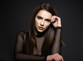 Naklejka premium Fashion model with long straight hair. Fashion model posing at studio.
