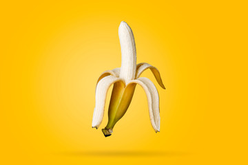 Banana entirely on a yellow background. Minimal fruit concept