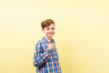 idea, enlightening, insight, comprehension. happy and confident grinning boy gesturing over yellow...