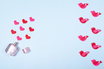 Flat lay arrangement of hearts and perfume bottle for mock up design, table top view image of decoration valentine's day background