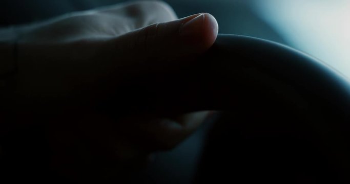 Close up young businessman is driving a new car just bought from auto deal. Slow motion shot in 8K. Concept of passion for driving cars and engines, car dealerships, used cars, luxury cars