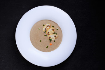 mushroom cream soup with herbs and spices, tasty nourishing lunch, starter meal. european cuisine, healthy food, restaurant menu