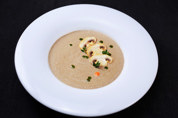 mushroom cream soup with herbs and spices, tasty nourishing lunch, starter meal. european cuisine, healthy food, restaurant menu