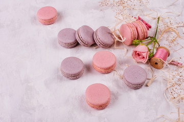 Wedding, St. Valentine's Day, birthday, preparation, holiday. Beautiful pink tasty macaroons on a concrete background