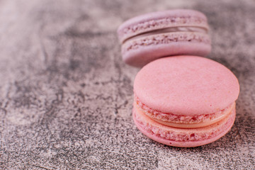 Wedding, St. Valentine's Day, birthday, preparation, holiday. Beautiful pink tasty macaroons on a concrete background