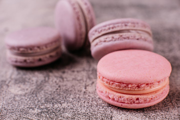 Wedding, St. Valentine's Day, birthday, preparation, holiday. Beautiful pink tasty macaroons on a concrete background