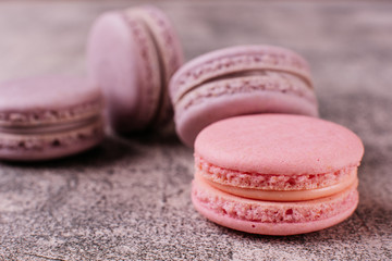 Wedding, St. Valentine's Day, birthday, preparation, holiday. Beautiful pink tasty macaroons on a concrete background