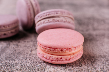 Wedding, St. Valentine's Day, birthday, preparation, holiday. Beautiful pink tasty macaroons on a concrete background