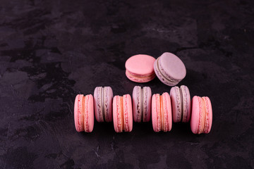 Wedding, St. Valentine's Day, birthday, preparation, holiday. Beautiful pink tasty macaroons on a concrete background