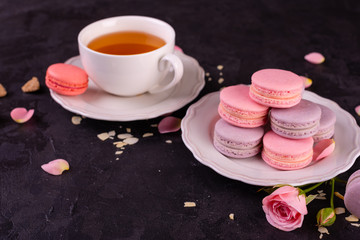 Wedding, St. Valentine's Day, birthday, preparation, holiday. Beautiful pink tasty macaroons on a concrete background