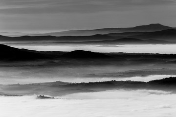 Fog filling a valley in Umbria (Italy), with layers of mountains and hills