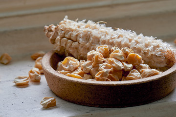 Dried sweet corn seed off the cob in a cork bowl ready for spring planting.