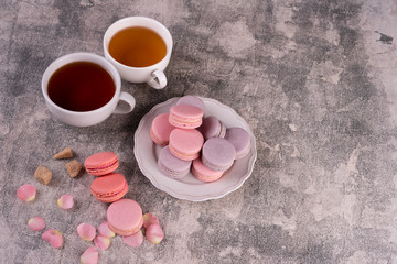 Wedding, St. Valentine's Day, birthday, preparation, holiday. Beautiful pink tasty macaroons on a concrete background