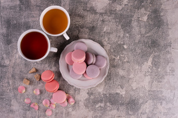 Wedding, St. Valentine's Day, birthday, preparation, holiday. Beautiful pink tasty macaroons on a concrete background