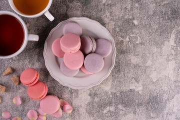 Wedding, St. Valentine's Day, birthday, preparation, holiday. Beautiful pink tasty macaroons on a concrete background