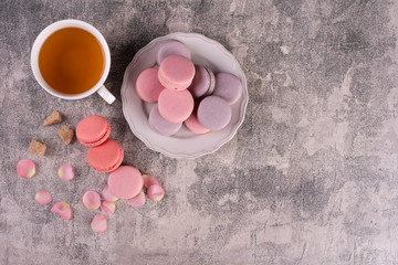 Wedding, St. Valentine's Day, birthday, preparation, holiday. Beautiful pink tasty macaroons on a concrete background