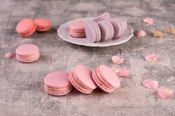 Wedding, St. Valentine's Day, birthday, preparation, holiday. Beautiful pink tasty macaroons on a concrete background