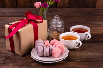 Wedding, St. Valentine's Day, birthday, preparation, holiday. Beautiful pink tasty macaroons on a concrete background