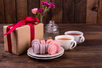 Wedding, St. Valentine's Day, birthday, preparation, holiday. Beautiful pink tasty macaroons on a concrete background