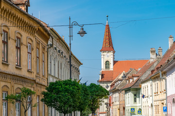 Obraz premium Sibiu, Romania - Beautiful street with Reformed Church on a sunny summer day in Sibiu, Romania