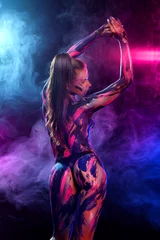 Fotobehang Young woman painted different colors. Inspired dance to music. Body art colorful. An amazing woman with art fashion makeup. © Mike Orlov