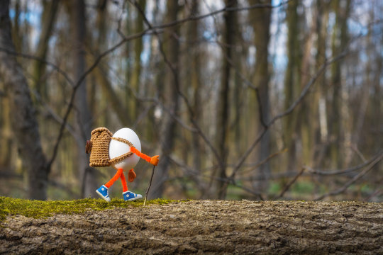 Easter egg hiker walking by the tree